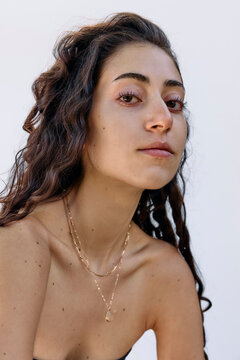 Young woman wearing a golden necklace outside 