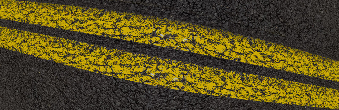 Bandes jaunes sur asphalte 