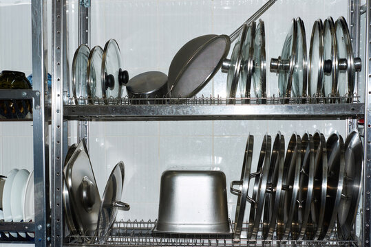 Kitchen storage with various stainless steel cookware and utensils