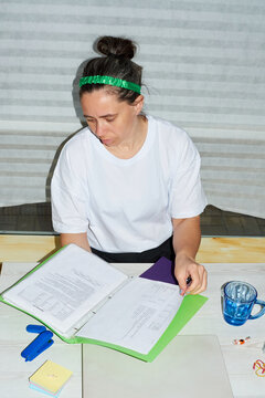An employee works with a folder in the office.