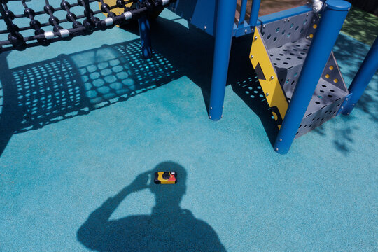 shadow of a young man holding a disposable film camera