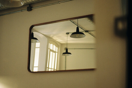 Reflection of Ceiling Lamps and Windows in Mirror
