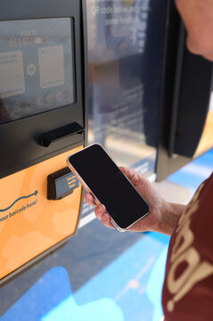 Community member engages with recycling kiosk for sustainable living