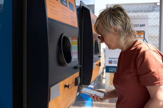 Engaging in recycling at a community kiosk for sustainable practices