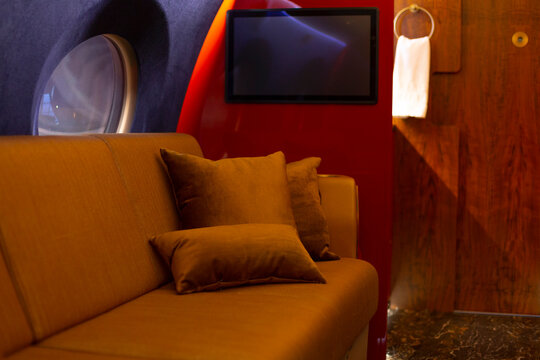 Luxurious aircraft lounge offering exclusive inflight movie experience. Lavish jet cabin featuring exclusive entertainment zones for passengers seeking elegance and comfort