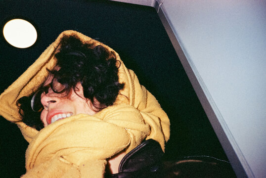 Smiling Person Wrapped in Yellow Scarf 