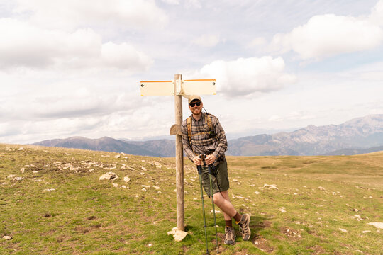 Hiker at trail sign