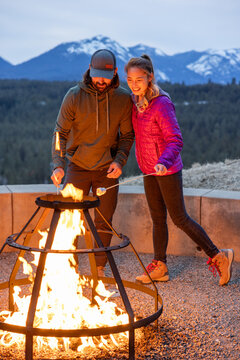 A couple roasting marshmallows