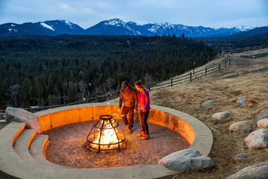 A couple roasting marshmallows  