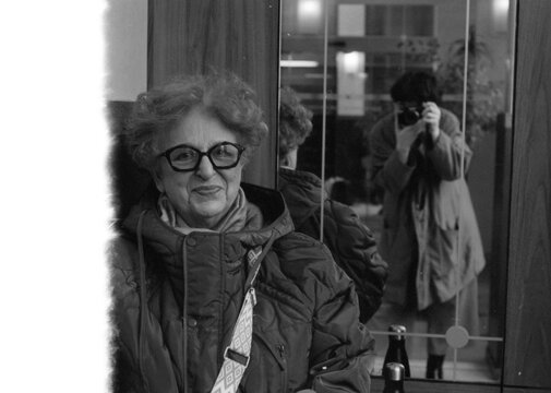 Portrait of a grandmother with photographer showing in a mirror.