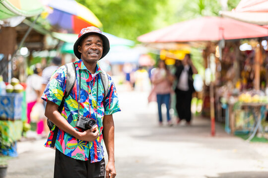 Smiling traveler enjoying a moment at a Thai street market
