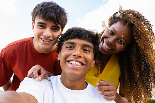 Happy multi-ethnic friends taking a selfie outdoors