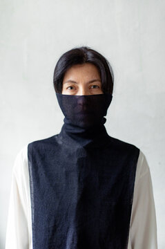 
portrait of a woman with her face half covered