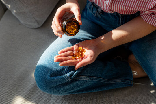 Close-Up of a Person Holding vitamins Capsules in Their Hand