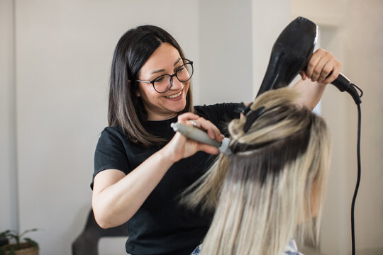 Hair Stylist Blow-Drying Client&rsquo;s Hair in Salon