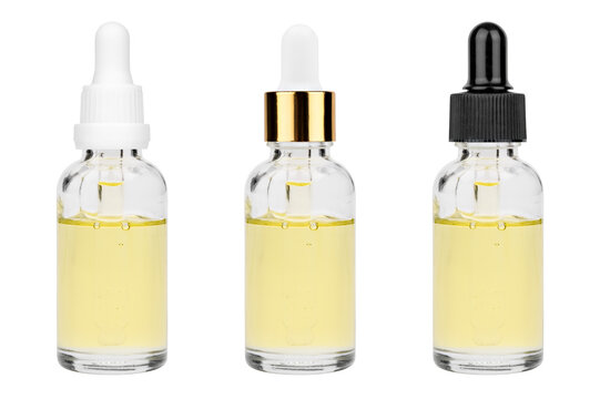 Glass bottle with cuticle oil and facial serum isolated on white background