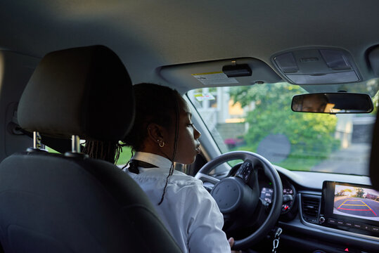 Young Driver Focused on Safe Driving During a Sunny Day