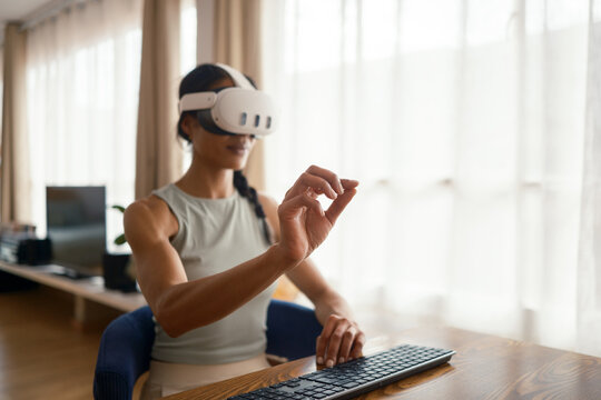 Woman using VR glasses at home