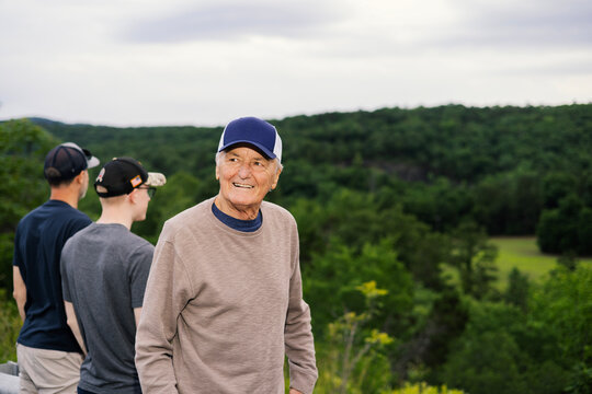 Happy Grandpa in front of Vista of Ozark Mountains in Arkansas