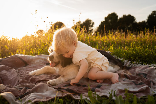 Baby hugging dog