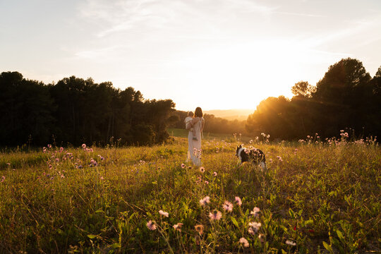 Mother child sunset field