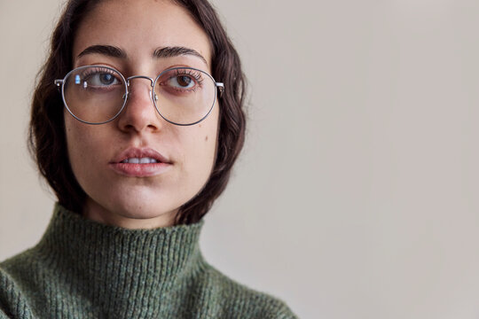 Young serious woman wearing eyeglasses in natural light