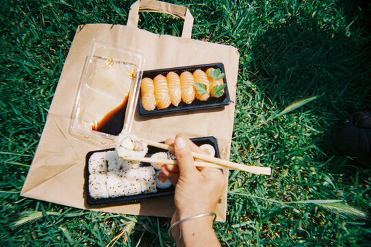 Eating Sushi Outdoors. Park picnic