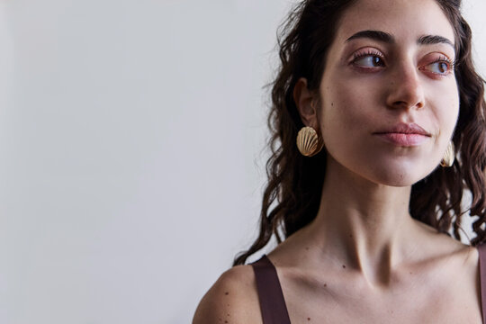 Young model with a seashell golden earring