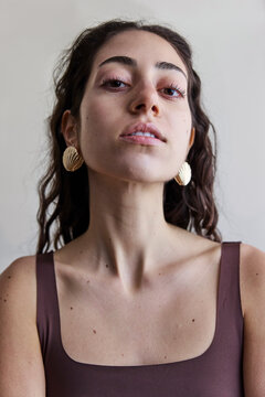Young model with a seashell golden earring