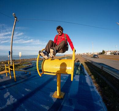 Man Exercising on Unique Outdoor Fitness Equipment by the Beach