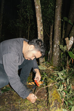 Camper settles a candle on the soil