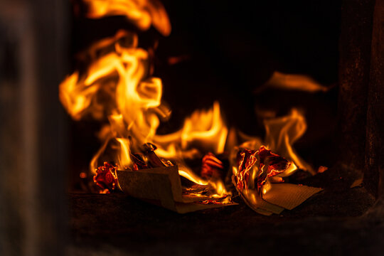 The moment the paper money burned fiercely inside the incense burner