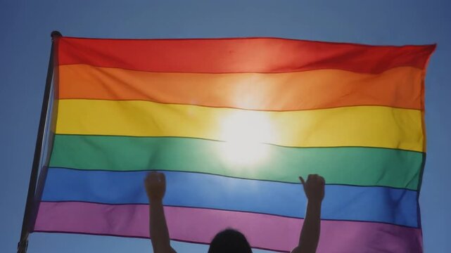 Rainbow Pride Flag Waving In The Blue Sky During Pride Month