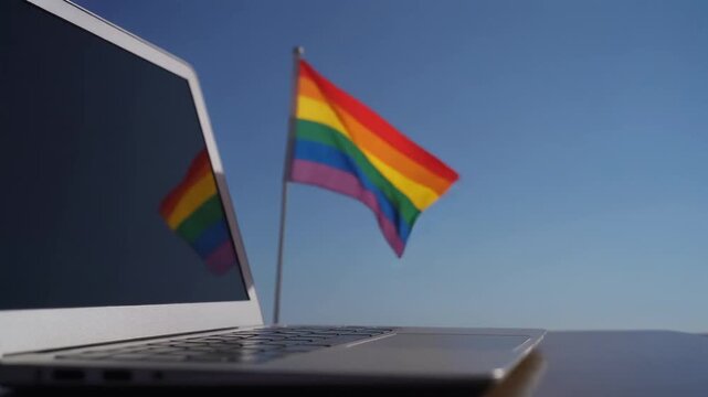 Laptop Computer With Lgbtq Pride Flag Waving In Background