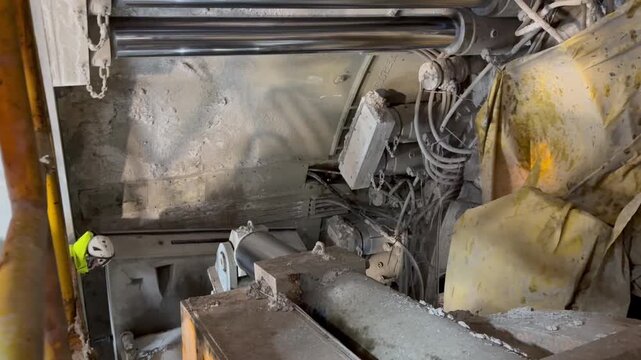 Railway tunnel excavation through mountainous terrain on line LK104 using TBM technology. Tunnel boring machine advancing underground with installation of precast concrete segments forming the tunnel.