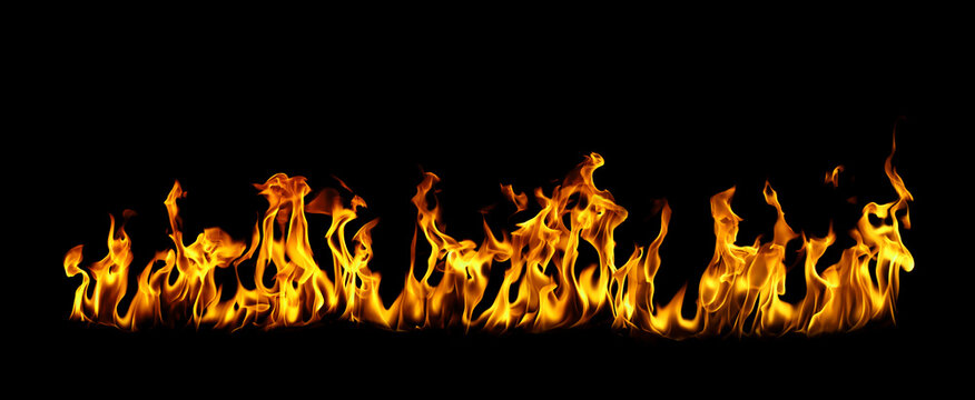 Burning fire flames isolated on black background, realistic orange and yellow blaze with intense heat and energy, abstract fire texture for danger concept, power, passion and dramatic design element.