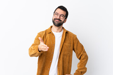 Caucasian handsome man with beard wearing a corduroy jacket over isolated white background shaking...