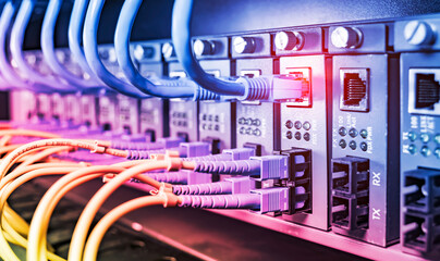 Fiber Optic cables connected to optic ports and UTP, Network cables connected to ethernet ports.