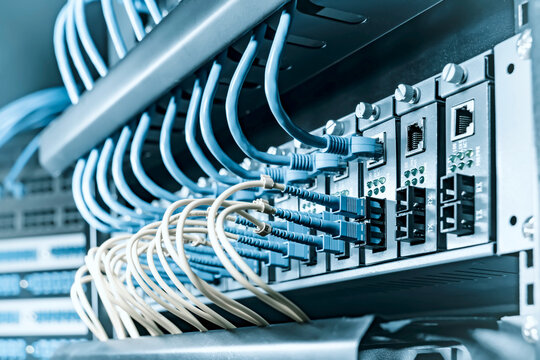 Fiber Optic cables connected to optic ports and UTP, Network cables connected to ethernet ports.