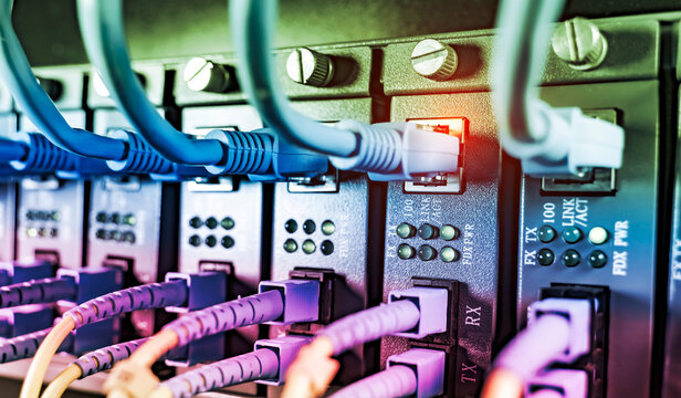 Fiber Optic cables connected to optic ports and UTP, Network cables connected to ethernet ports.