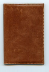 Fototapeta premium Brown leather passport cover. Jacket. Document case. Folder. Dust cover. Covering for a book, notebook or any other kind of papers