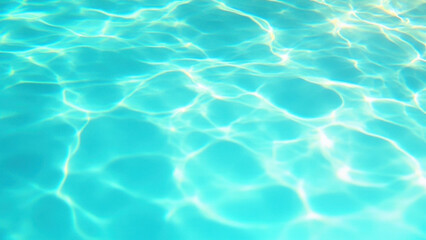 Obraz premium Bright sunlight creates shimmering patterns on the surface of clear blue swimming pool water
