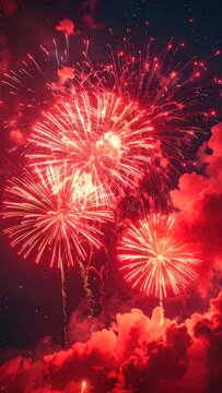 Vibrant Red Fireworks Illuminating Dark Night Sky with Crimson Clouds