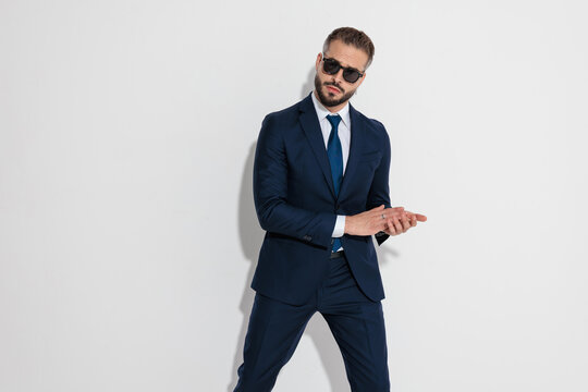 Cunning man in suit rubbing hands together