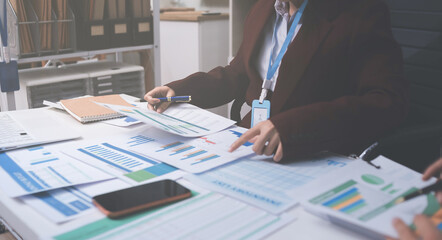 Fototapeta premium Accounting company provide finance and taxation planning for profitable cash flow, Auditor and accountant team working in office, analyze financial data and accounting record with calculator