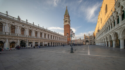 Naklejka premium The photograph depicts St Mark's Square (Piazza San Marco) in Venice. Dominating the square is the bell tower (Campanile di San Marco)