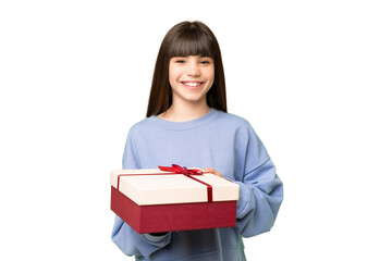 Fototapeta premium Little girl holding a gift over isolated chroma key background smiling a lot