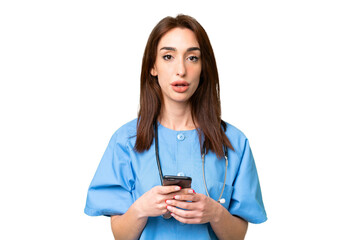 Fototapeta premium Young nurse woman over isolated chroma key background surprised and sending a message
