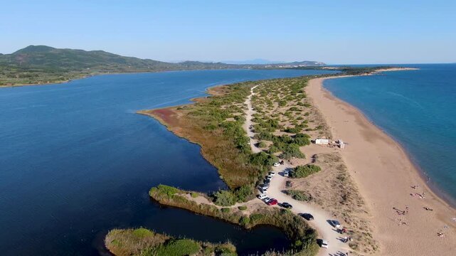 Aerial drone shot of Halikounas Beach and Lake Korission in Corfu Greece showing the narrow sandbar separating the lagoon from the Ionian Sea