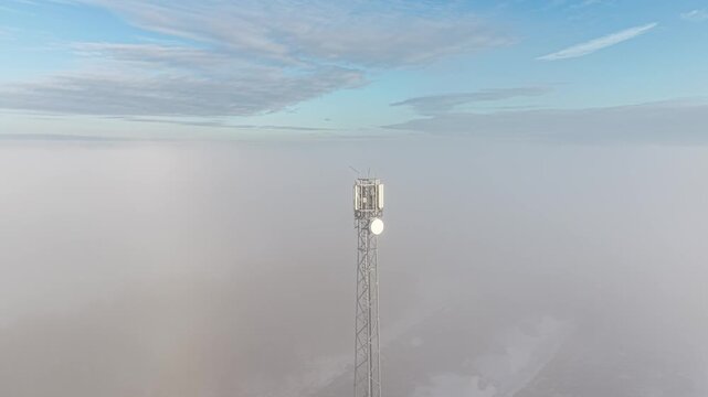 Mobile communication mast above foggy terrain